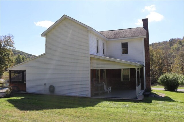 rear view of property featuring a yard