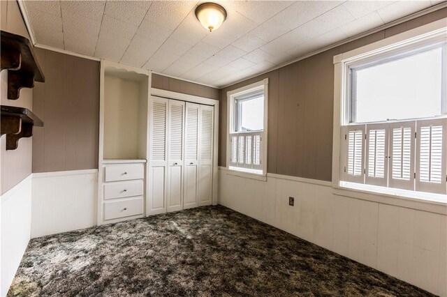 unfurnished bedroom featuring carpet and a closet