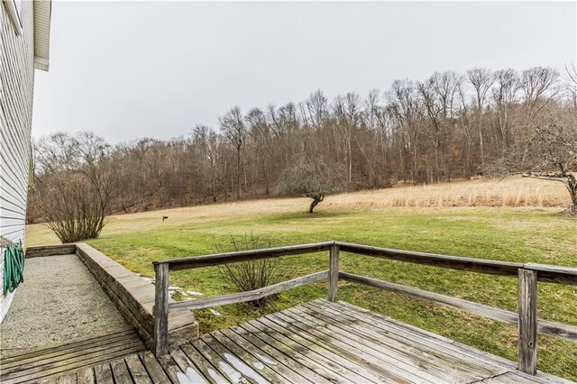 wooden terrace featuring a lawn