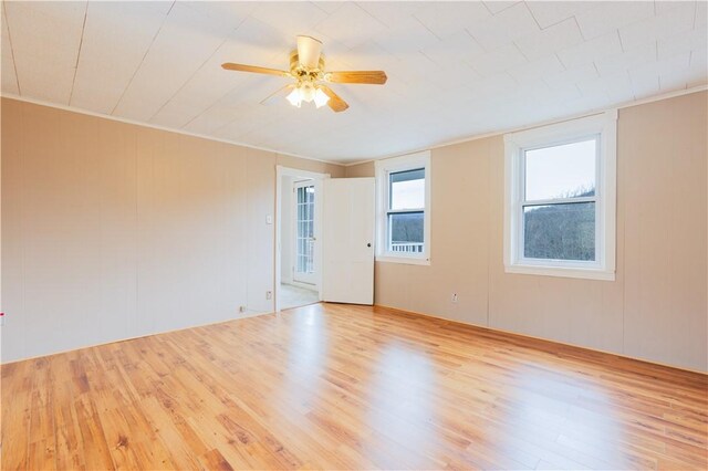 spare room with ceiling fan and light wood-type flooring