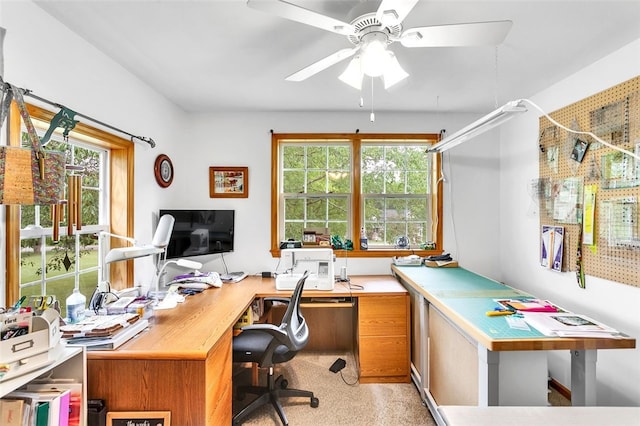 office space with ceiling fan, light carpet, and a healthy amount of sunlight