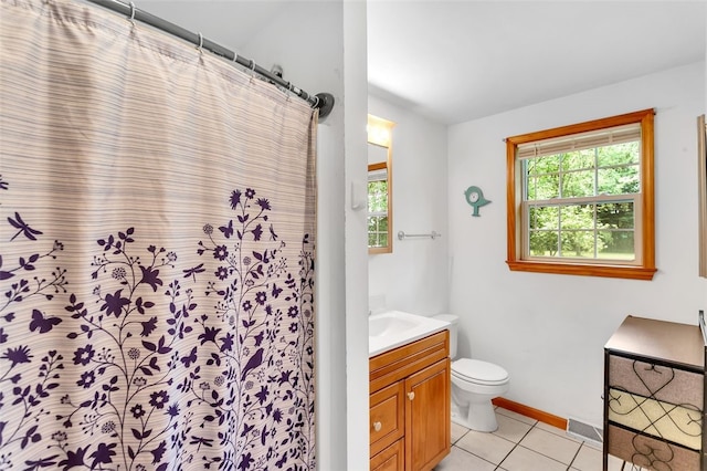 bathroom with tile patterned flooring, vanity, and toilet