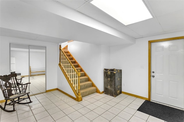 tiled foyer entrance with a drop ceiling