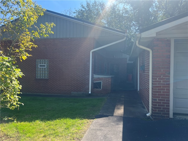 view of side of property with a garage and a yard