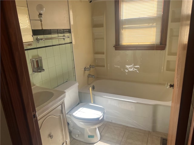 full bathroom featuring tub / shower combination, vanity, tile walls, and toilet