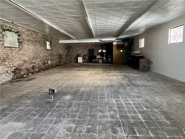 basement featuring brick wall