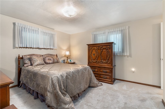 carpeted bedroom featuring a textured ceiling