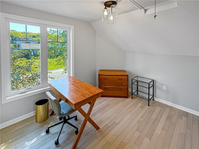 office space with lofted ceiling and light hardwood / wood-style floors