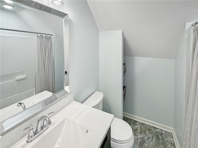 bathroom featuring walk in shower, lofted ceiling, vanity, and toilet