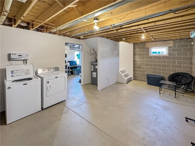 basement featuring electric water heater and washer and clothes dryer