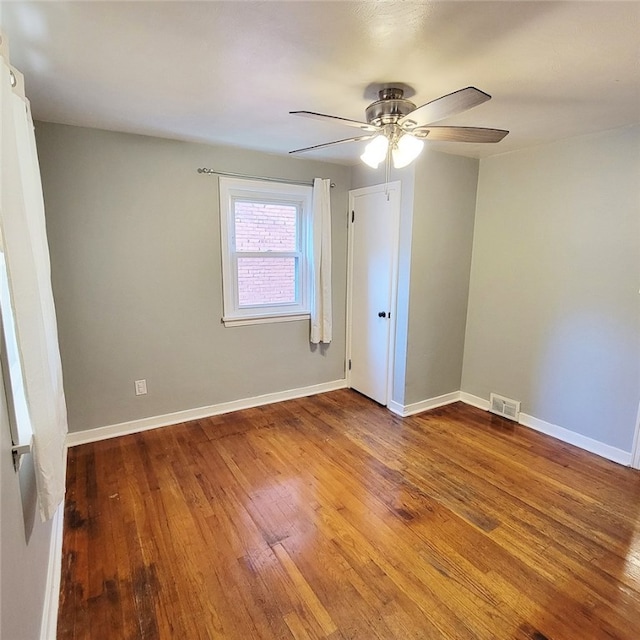 empty room featuring ceiling fan and hardwood / wood-style floors