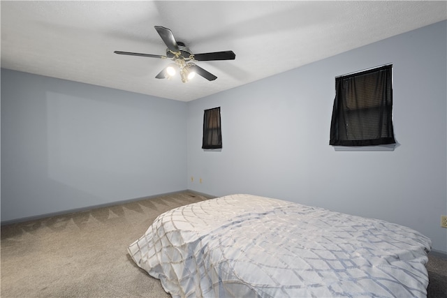 bedroom with ceiling fan and carpet floors