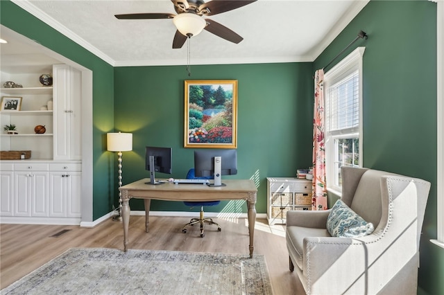 office featuring light hardwood / wood-style floors, ornamental molding, and ceiling fan