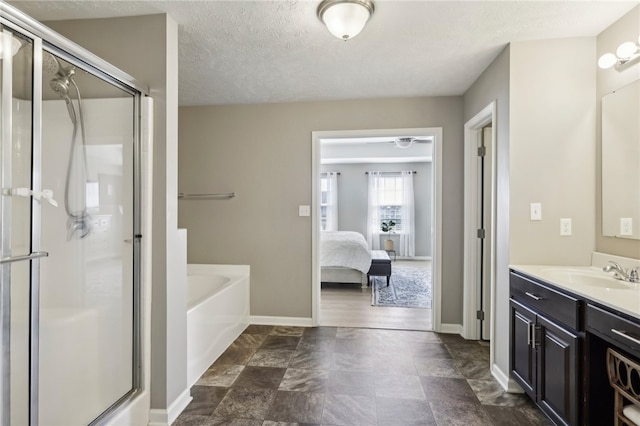 bathroom with independent shower and bath, vanity, and a textured ceiling