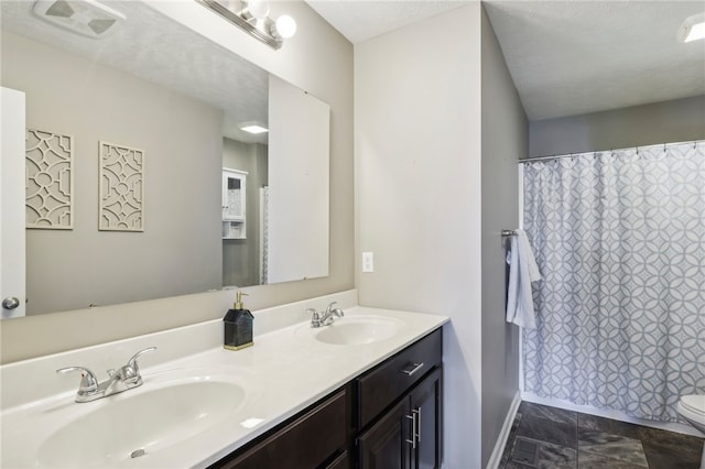 bathroom with a shower with shower curtain, a textured ceiling, vanity, and toilet