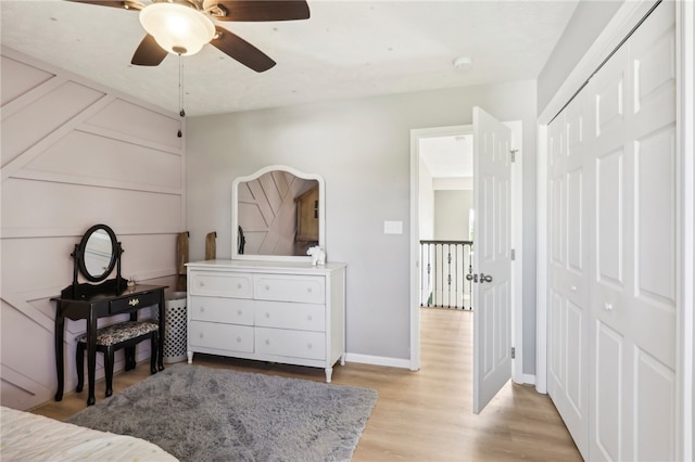 bedroom featuring light wood-type flooring, ceiling fan, and a closet