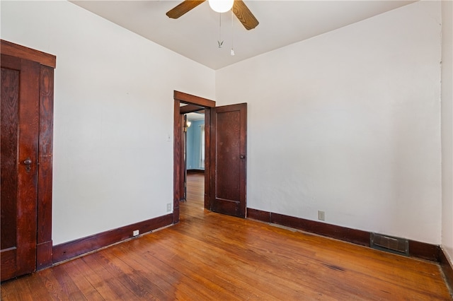 spare room with hardwood / wood-style floors and ceiling fan