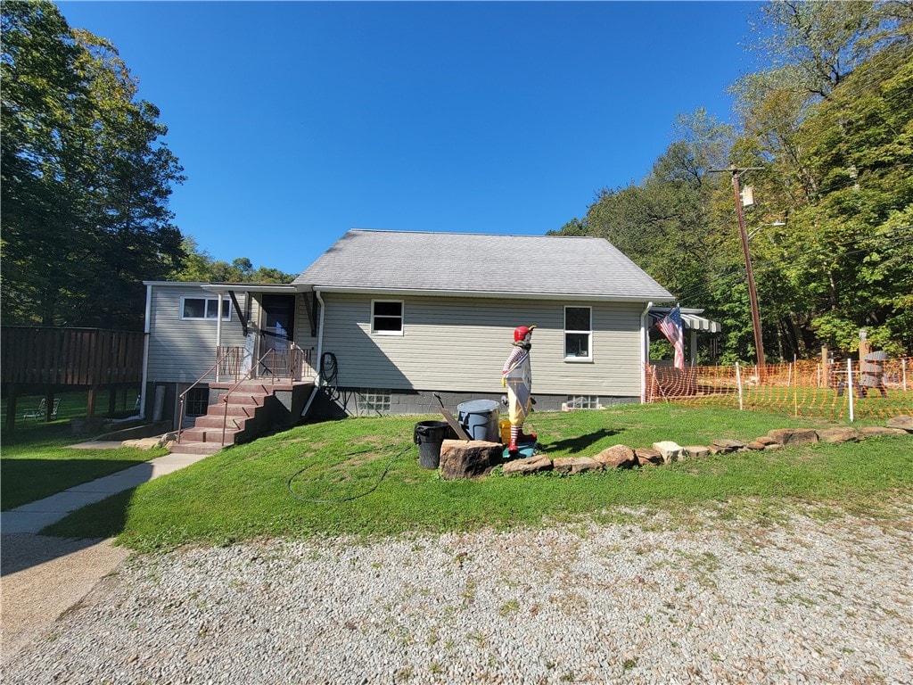 bungalow-style home with a front lawn