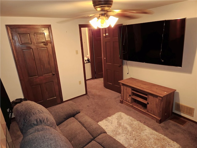 carpeted living room with ceiling fan