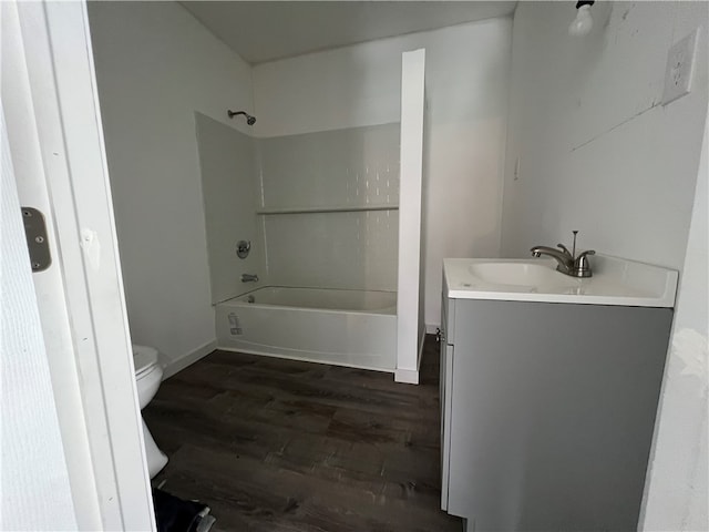 full bathroom with shower / tub combination, vanity, hardwood / wood-style floors, and toilet