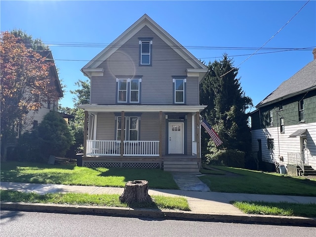 view of property with a porch and a front lawn