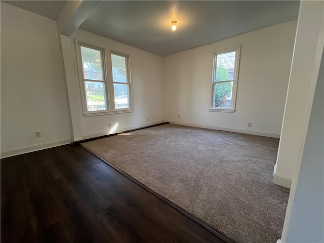 empty room with dark hardwood / wood-style floors