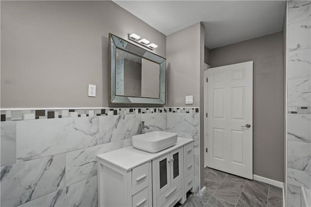 bathroom with vanity and tile walls