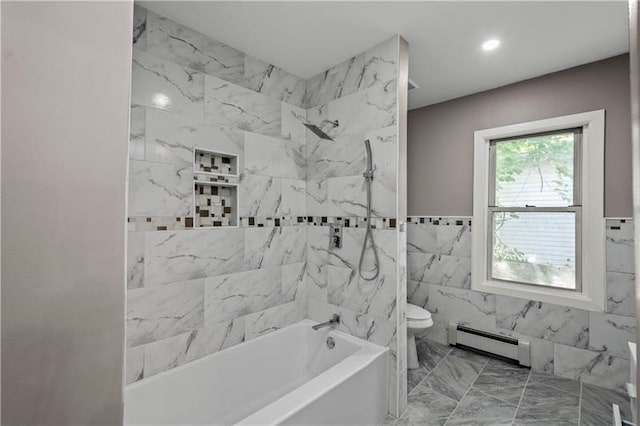 bathroom featuring tile walls, toilet, baseboard heating, and tiled shower / bath