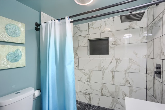 bathroom featuring walk in shower and toilet