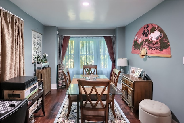 dining area with radiator and dark wood-type flooring