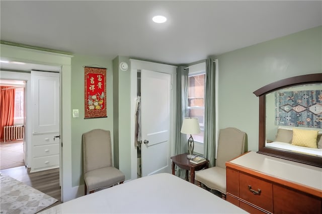 bedroom featuring dark hardwood / wood-style flooring and radiator heating unit