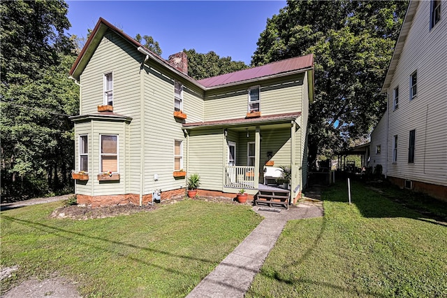 view of front facade with covered porch and a front yard