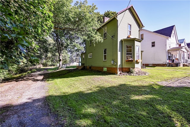 view of side of home with a lawn