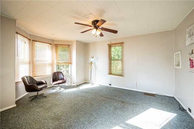 unfurnished room with ceiling fan, carpet floors, and a healthy amount of sunlight