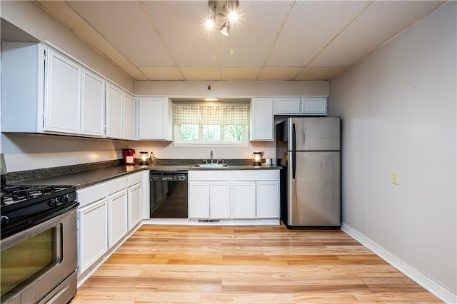 kitchen with stainless steel appliances, white cabinets, light hardwood / wood-style floors, and sink