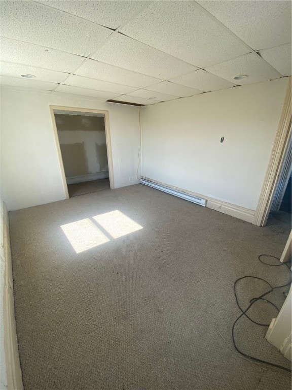 unfurnished room with a paneled ceiling and carpet flooring