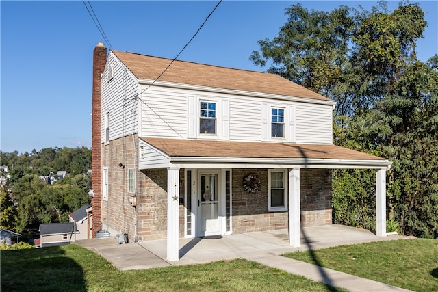 view of front of house with a front yard and a porch