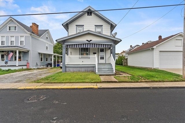 view of front of home featuring a front lawn, a garage, and covered porch