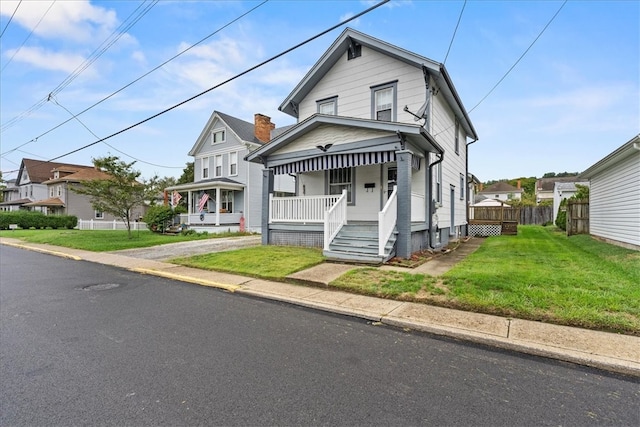 bungalow-style house featuring a front lawn and covered porch