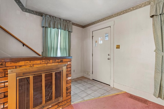 entryway with light tile patterned floors and a wealth of natural light