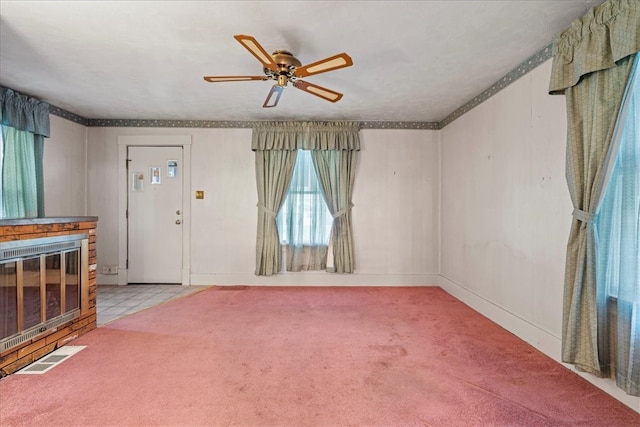 interior space with a fireplace and ceiling fan