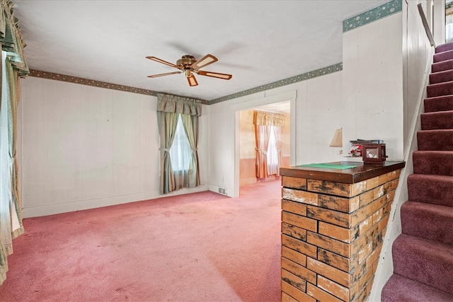 interior space with ceiling fan and carpet floors