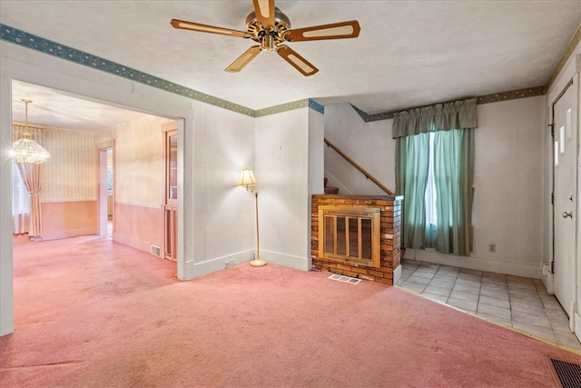 unfurnished living room with a brick fireplace, lofted ceiling, ceiling fan, and carpet flooring