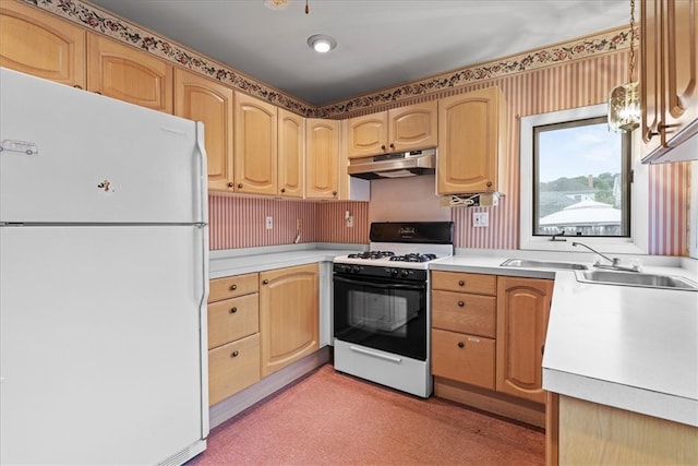 kitchen featuring light brown cabinetry, hanging light fixtures, white appliances, and sink