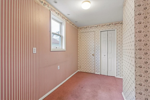 unfurnished bedroom featuring carpet and a closet