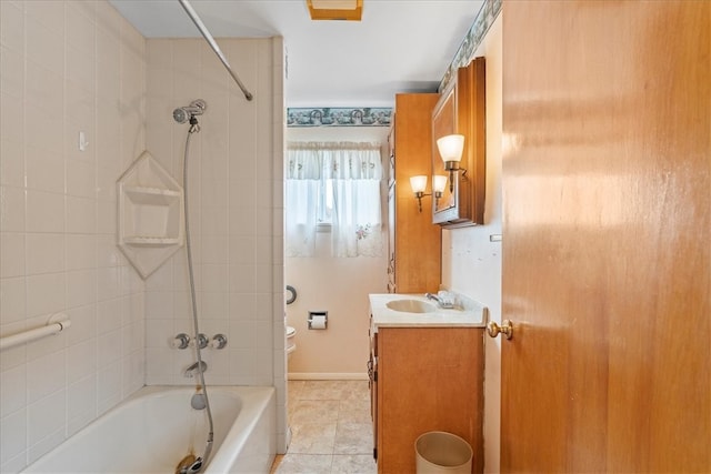 full bathroom featuring tile patterned flooring, vanity, toilet, and tiled shower / bath