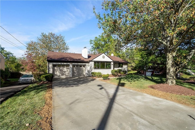 view of front facade with a garage and a front lawn