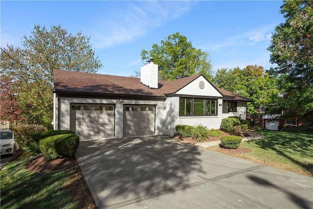 single story home featuring a front yard and a garage