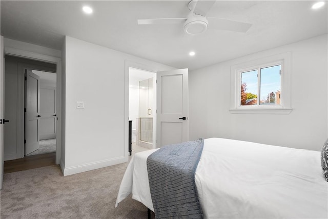 bedroom with connected bathroom, ceiling fan, and light carpet