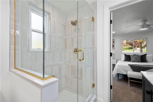 bathroom with ceiling fan, an enclosed shower, and a wealth of natural light